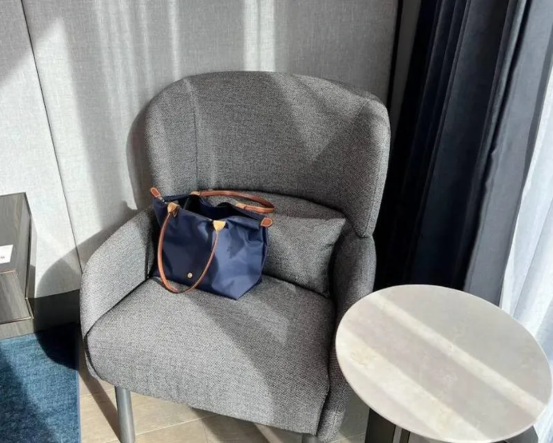 Desk with relaxing chair having bag serve as waiting area 